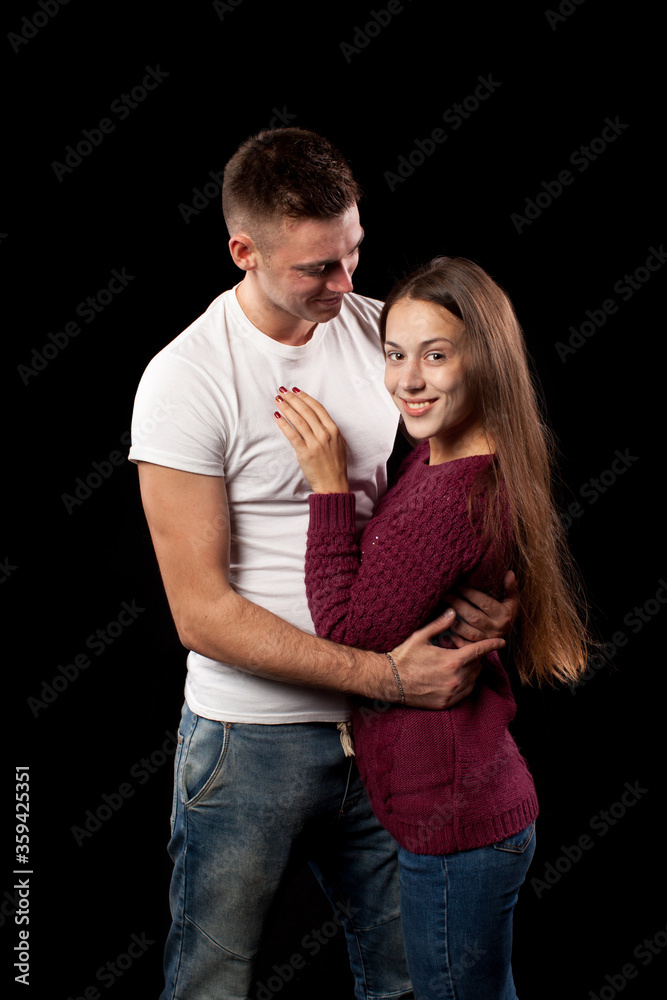Smiling happy loving couple in studio on black background Smiling happy loving couple in studio on black background