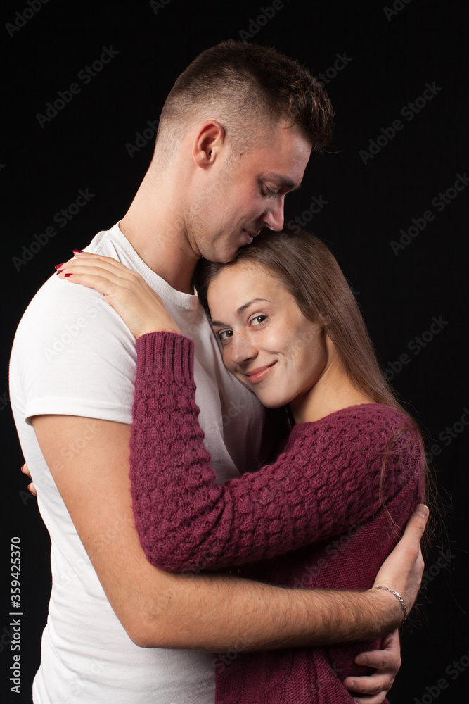 Smiling happy loving couple in studio on black background Smiling happy loving couple in studio on black background