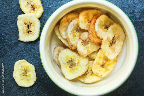 banana chips sweet and healthy snack Menu concept serving size. food background top view copy space for text