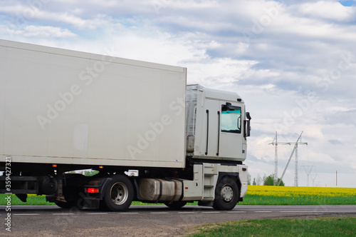 Truck with container on highway, cargo transportation concept. Shaving effect.