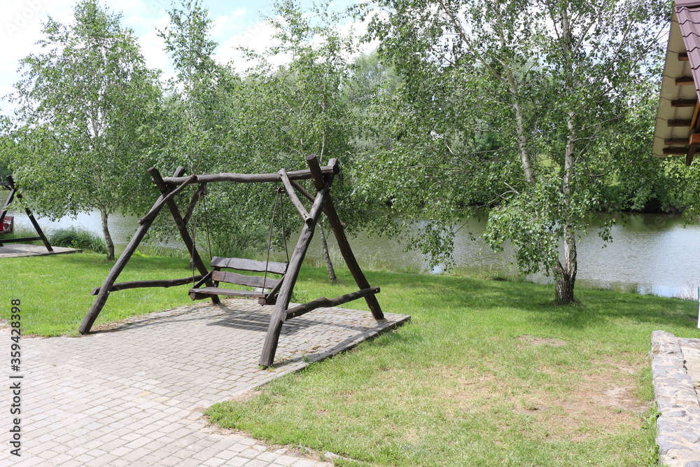 The recreation center in ethno style is a favorite vacation spot in Ukraine. Children and adults love to ride wooden swings.