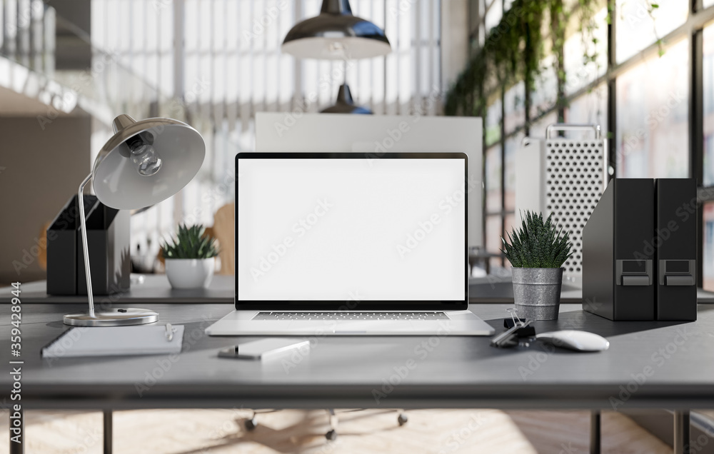Fototapeta premium Laptop blank screen in an industrial office interior
