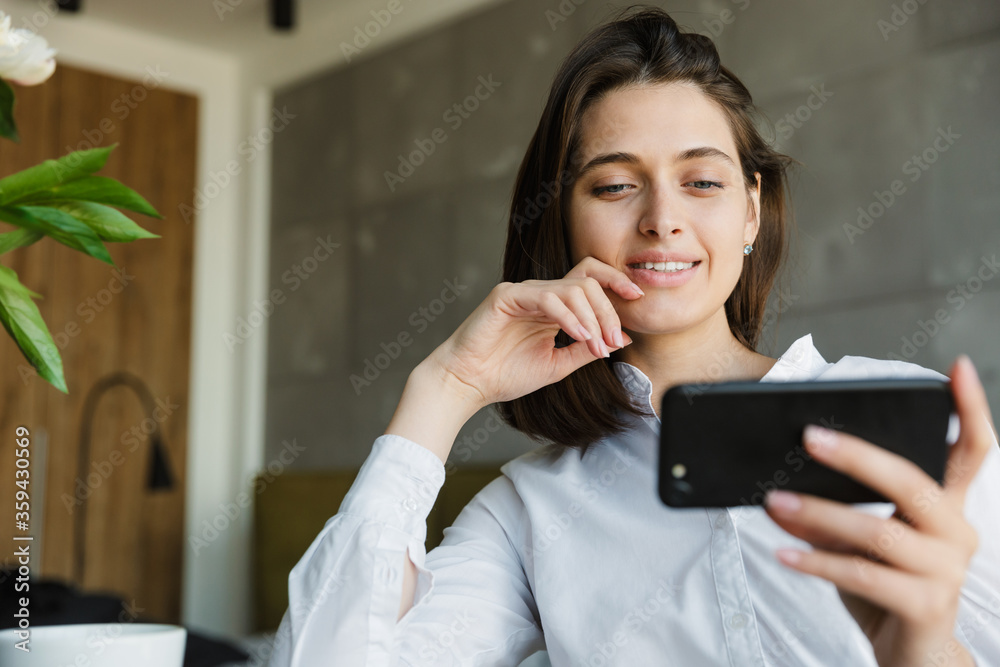 Attractive smiling young lovely brunette woman watching video Attractive smiling young lovely brunette woman watching video