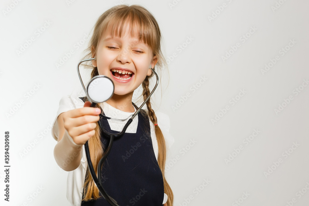 Smiling little girl playing doctor with stethoscope isolated on white Smiling little girl playing doctor with stethoscope isolated on white
