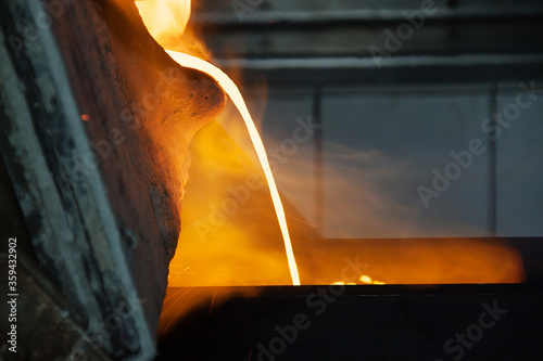 Gold smelting at a metallurgical plant. Liquid gold pouring into bowls to transfer gold to gold bullion