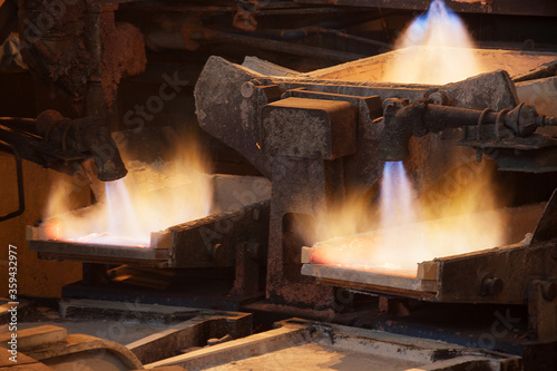 Daytime general view of the copper smelting shop at a metallurgical plant. Casting copper into bowls for further cooling