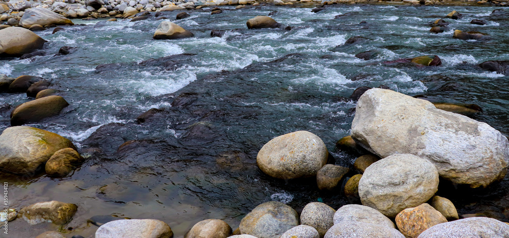flowing river having rocks in the river