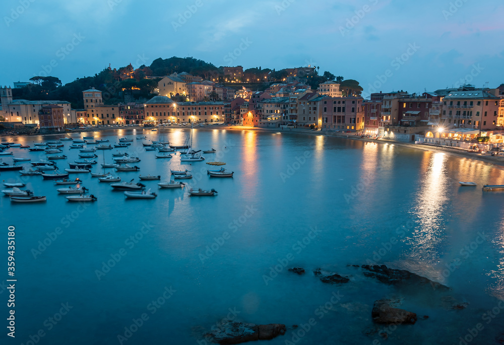 Breathtaking view of the bay with boats and yachts. Warm summer evening in the resort town. Romantic vacation. Sestri Levante, Bay of Silence