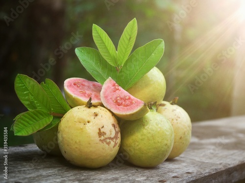 Red guava and green leaves on bokeh background. Tropical fruit concept
