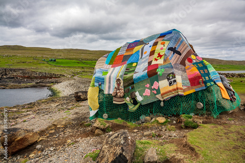 Eldgos and frumskogur the boulder covered with clothes in Sandoy photo