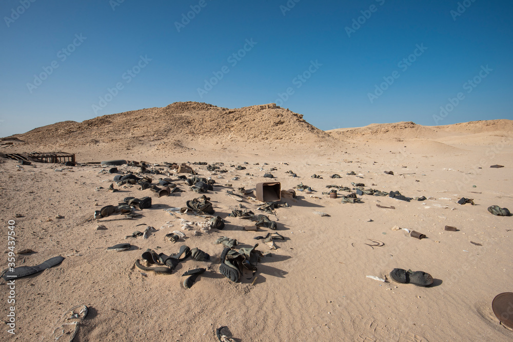 Old military army boots abandoned in remote african desert Old military army boots abandoned in remote african desert