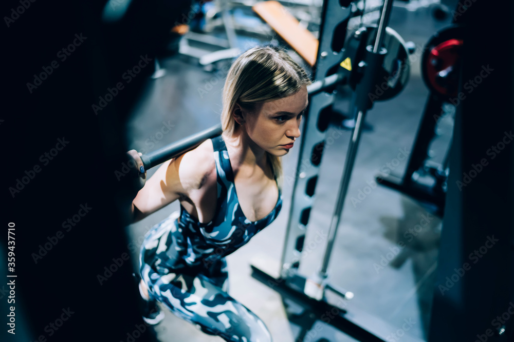 Determined strong woman lifting weights Determined strong woman lifting weights