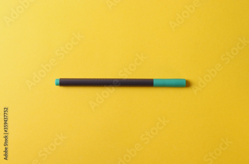 stationary pens on vivid colour yellow background. minimalism style