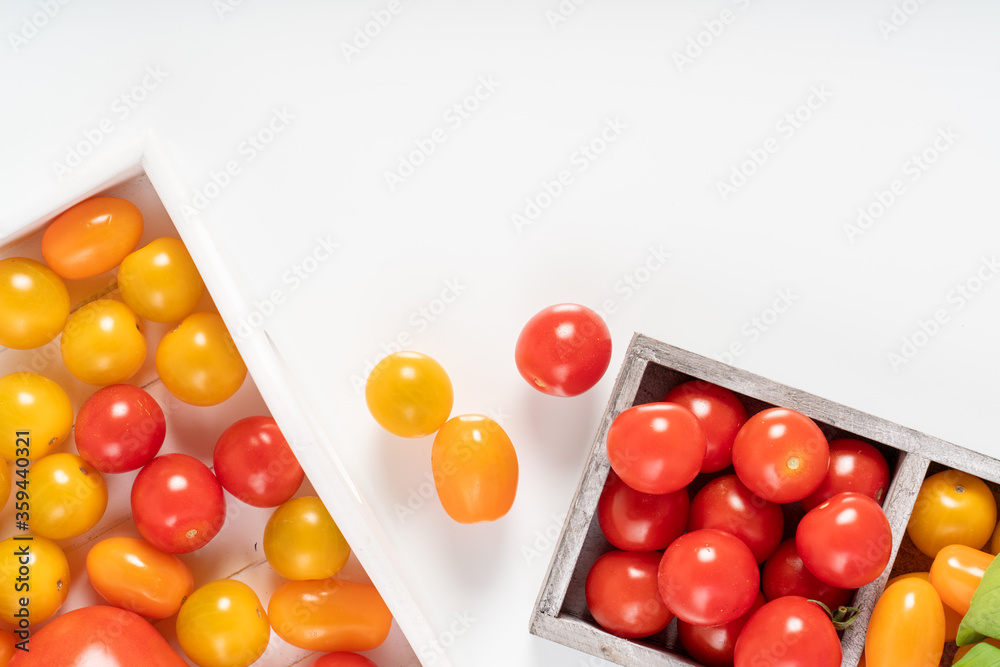 Ripe cherry tomatoes in a wooden box.