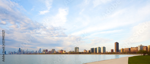 Apartment buildings in the waterfront of Montrose Harbor and downtown city skyline of Chicago at dawn, Illinois, United States.