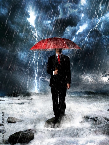 businessman with umbrella and rain
