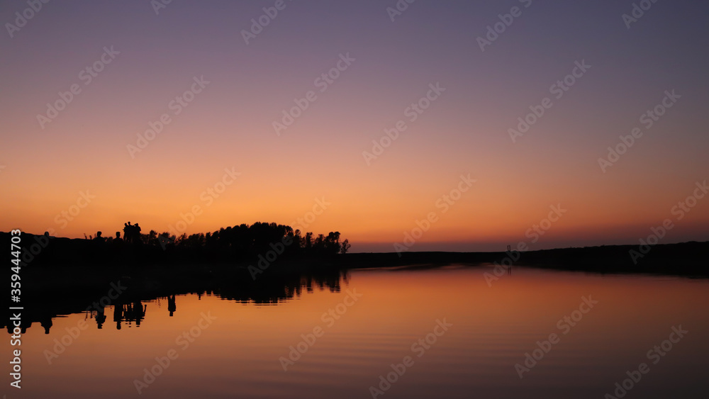Beautiful landscape of sunset reflected on a lake on summer