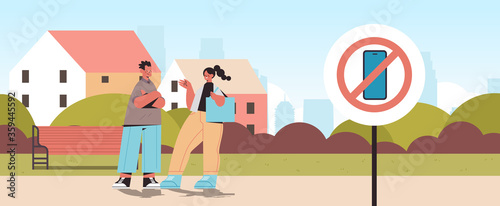 couple walking urban park no cellphone zone digital detox concept smartphone in prohibition sign abandoning internet social networks cityscape background horizontal vector illustration