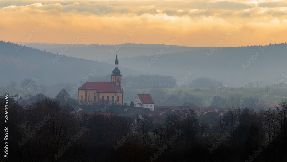 Fototapeta premium Small village in the foggy morning light