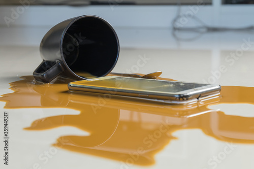 The smartphone fall on the floor and broken with coffee spilled 
