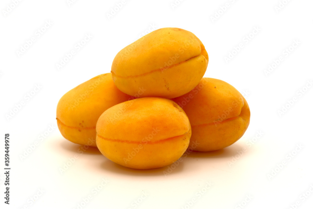 Four ripe apricot on a light background. Natural fruits. Close-up. Four ripe apricot on a light background. Natural fruits. Close-up.