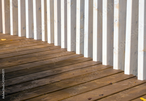 Vertical fencing boards connected to wood flooring