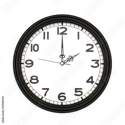 Black round analog wall clock isolated on white background, its two oclock.