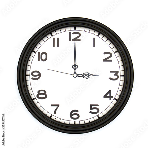 Black round analog wall clock isolated on white background, its three oclock.
