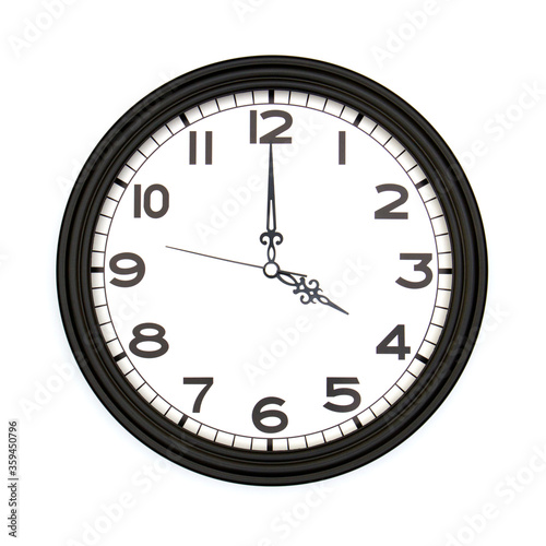 Black round analog wall clock isolated on white background, its four oclock.