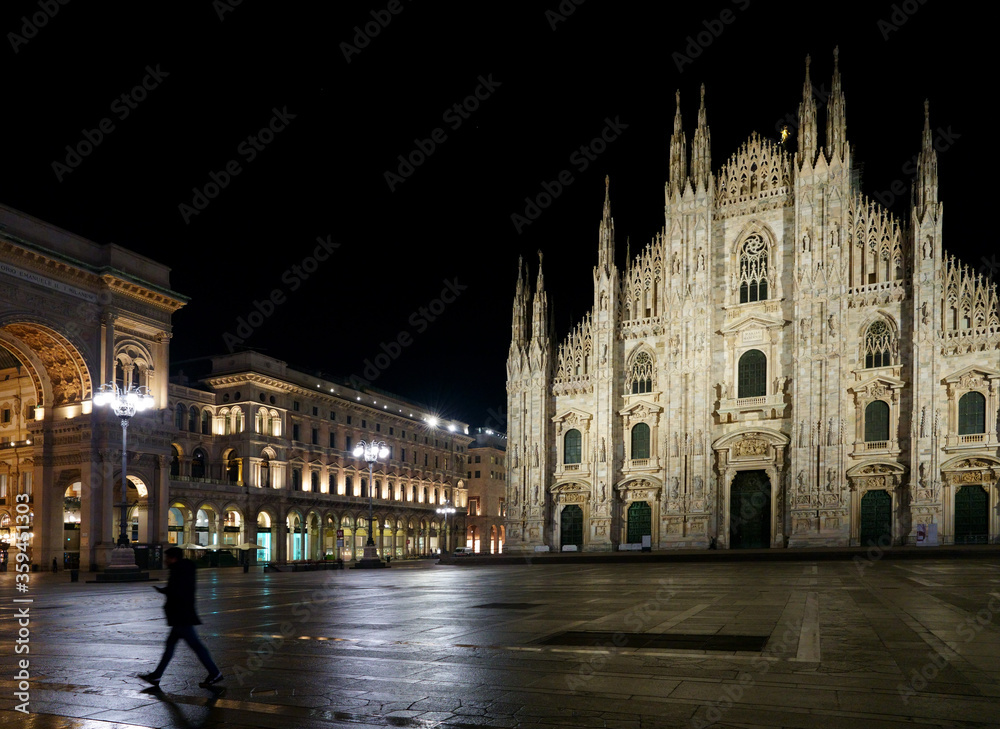 A man rushing past the Duomo in Milan, Italy