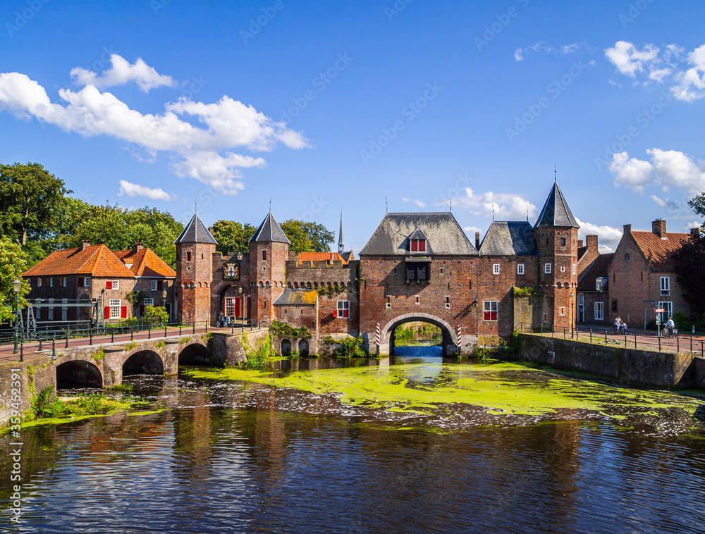 Medieval brick, city gate over the water on a beautiful sunny day