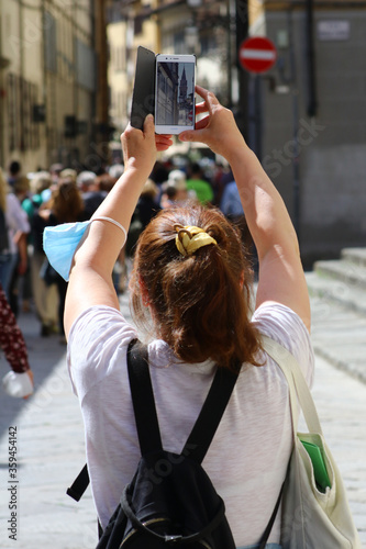 ourist in the streets of Florence photographing with cell phone, Florence, Tuscany, Italy photo