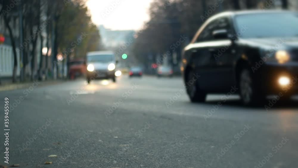 City traffic. Cars and motor bike are moving on the street road in cinematic bokeh City traffic. Cars and motor bike are moving on the street road in cinematic bokeh