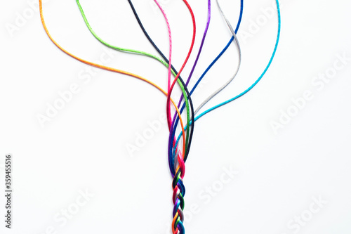 Obraz na plátne Coloured String Woven Together To Illustrate Concepts Of Unity Society Togethern
