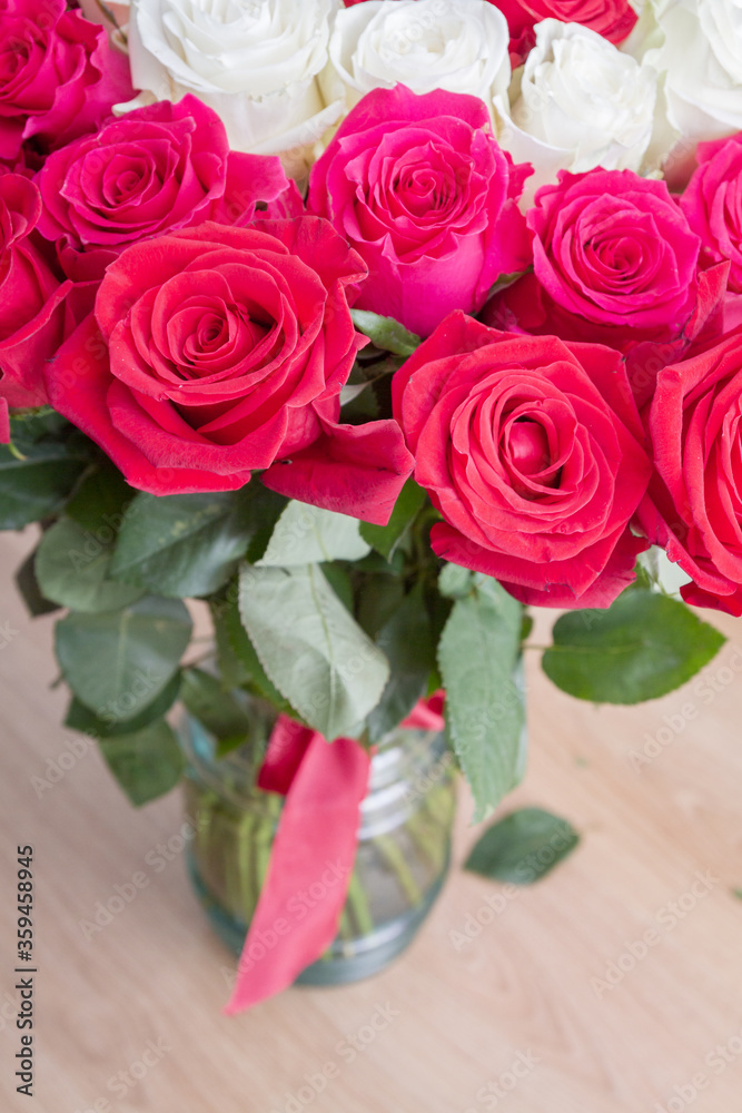 Multi-colored bouquet of red, pink and white roses in a vase Multi-colored bouquet of red, pink and white roses in a vase