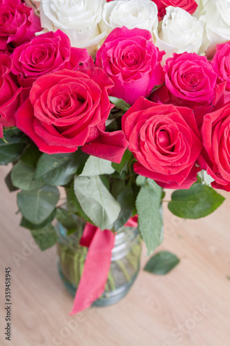 Multi-colored bouquet of red  pink and white roses in a vase
