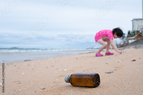 Children pick up trash on the beach, dirty sea 