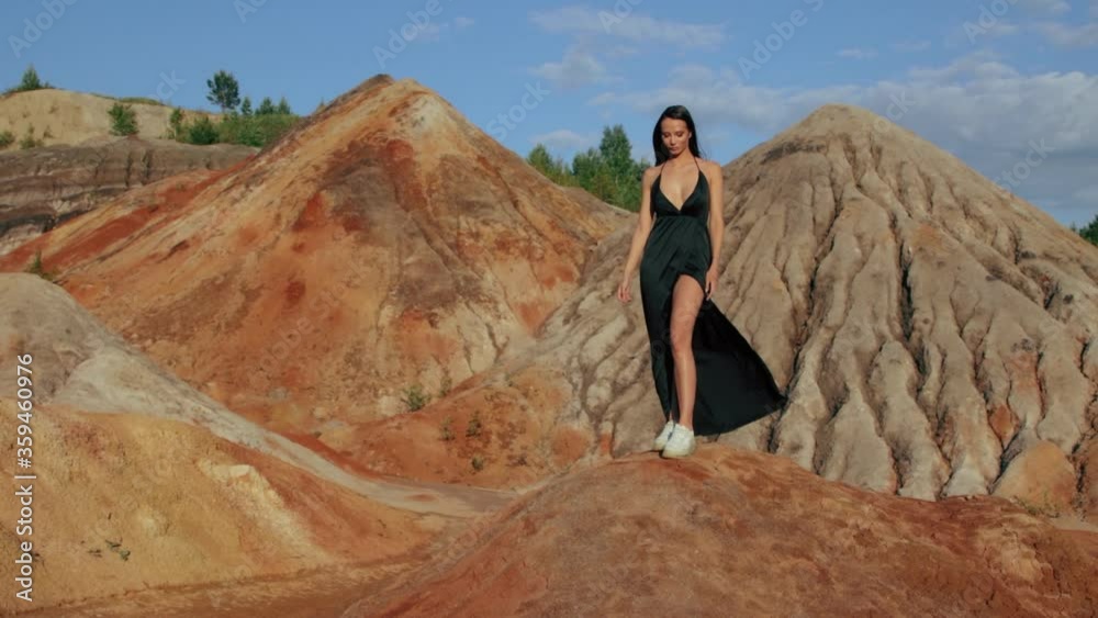 Beautiful woman posing on other-worldly hilly landscape Beautiful woman posing on other-worldly hilly landscape