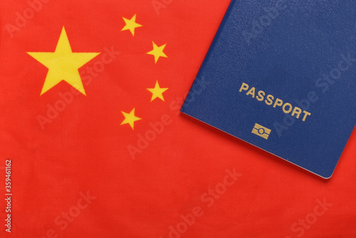 Photography Travel concept. Passport against the background of the China flag