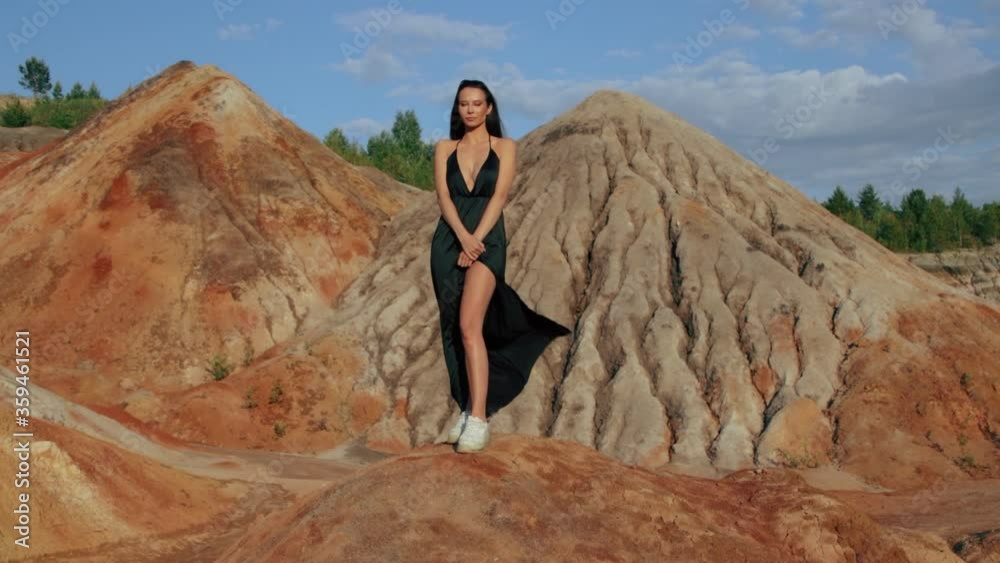 Beautiful woman posing on other-worldly hilly landscape Beautiful woman posing on other-worldly hilly landscape