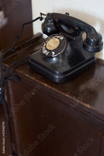 Retro black telephone placed on top of old compartment