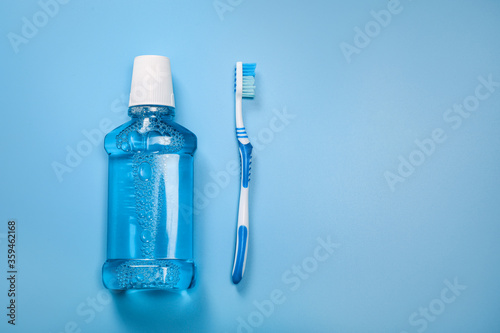Blue mouthwash and plastic toothbrush