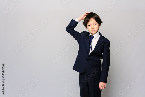 Portrait of an Asian schoolboy thinking 