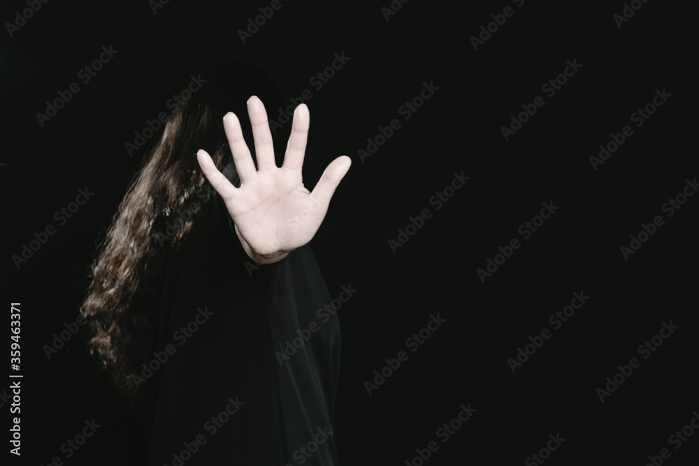 A woman shows a gesture of denial and protection, stop sign A woman shows a gesture of denial and protection, stop sign