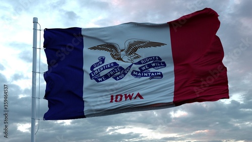 Flag of Iowa waving in the wind against deep beautiful clouds sky. 3d rendering