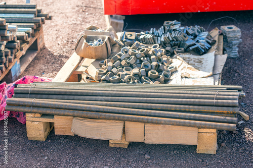 View of the group of steel anchor bolts, nuts and washers in the construction site. Anchor bolts are used to connect structural and non-structural elements to the concrete.