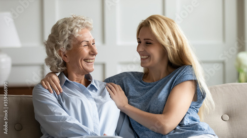 Grown up daughter and elderly 65s mother meeting at ancestral home. Adult child visit her old mom relatives spend weekend together enjoy talk pleasant warm honest conversation, share news and laughing