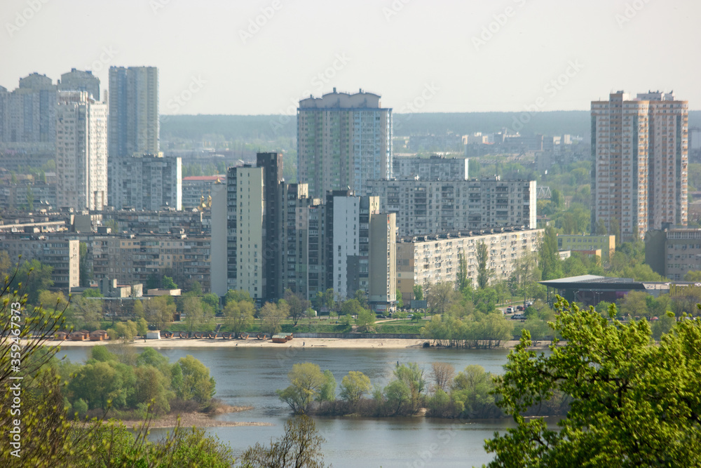 Fototapeta premium Landscape view of Kyiv on Dnipro river. View of Dnieper river with modern buildings in the background. Kiev, Ukraine.
