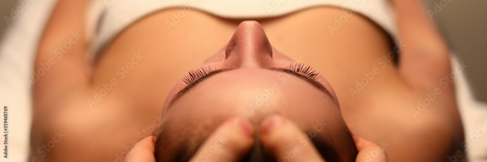 Close-up of wonderful woman relaxing massage on spa treatments in salon. Beautiful female person enjoying in beautician. Beauty and relaxation concept - obrazy, fototapety, plakaty 