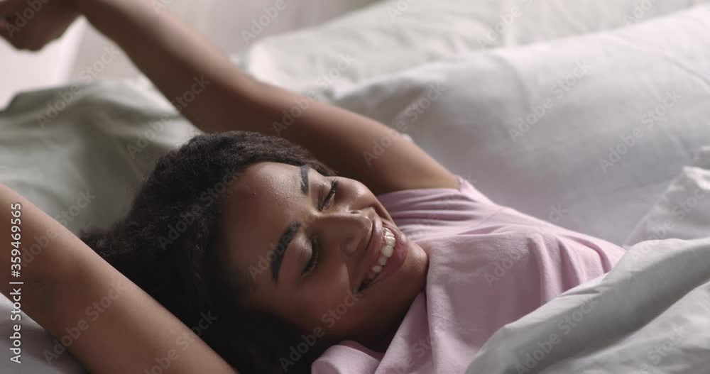 Good rested black woman stretching in morning in bed Good rested black woman stretching in morning in bed
